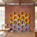 Colored wall bookcase with cells Slide Hexa, produced in Italy